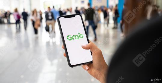 BERLIN, GERMANY JANUARY 2020:  Woman hand holding iphone Xs with logo of Grab application in a pedestrian zone. Grab is smartphone app all-in-one transport booking in South-East Asia.  : Stock Photo or Stock Video Download rcfotostock photos, images and assets rcfotostock | RC Photo Stock.: