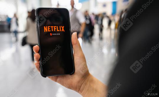 BERLIN, GERMANY JANUARY 2020: Netflix app on Apple iPhone. Young woman is browsing the movie video library what to watch.  : Stock Photo or Stock Video Download rcfotostock photos, images and assets rcfotostock | RC Photo Stock.: