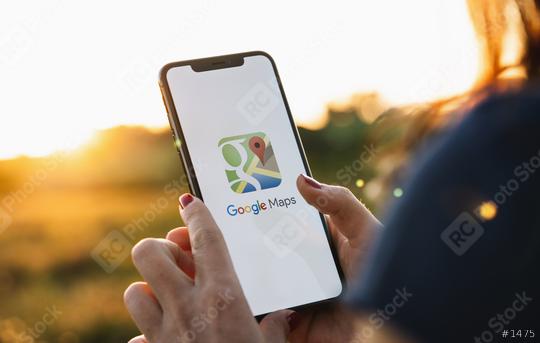 BERLIN, GERMANY JULY 2019: Hand Holding Smartphone with Google Maps application o. Google Maps is a service that provides information about geographical regions and sites around the world.  : Stock Photo or Stock Video Download rcfotostock photos, images and assets rcfotostock | RC Photo Stock.: