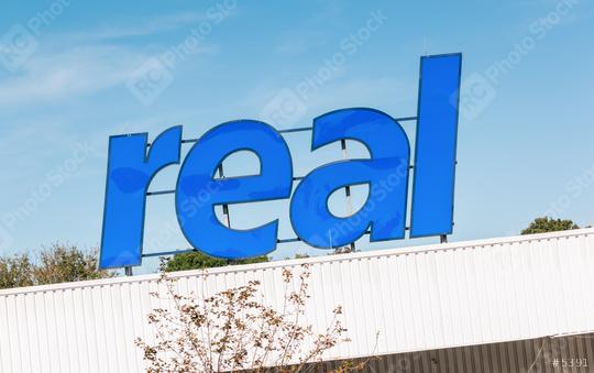 BERLIN, GERMANY JULY 2019: Real Logo from Real supermarket. Real is a retail chain of the Metro Group, which operates several hundred supermarkets through the Real Group Holding GmbH in Germany.  : Stock Photo or Stock Video Download rcfotostock photos, images and assets rcfotostock | RC Photo Stock.: