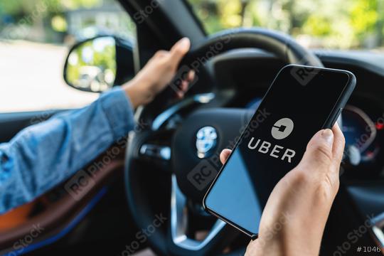 BERLIN, GERMANY JULY 2019: Uber driver holding smartphone in car. Uber is an American company offering transportation services online. Illustrative editorial.  : Stock Photo or Stock Video Download rcfotostock photos, images and assets rcfotostock | RC Photo Stock.: