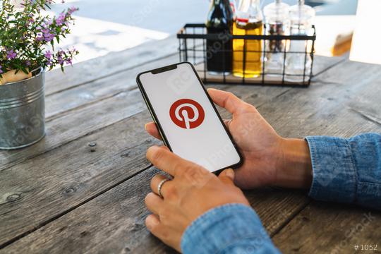 BERLIN, GERMANY JULY 2019: Woman hand holding iphone Xs with logo of Pinterest application in a restaurant. Pinterest is an online pinboard that allows people to pin their interesting things.  : Stock Photo or Stock Video Download rcfotostock photos, images and assets rcfotostock | RC Photo Stock.: