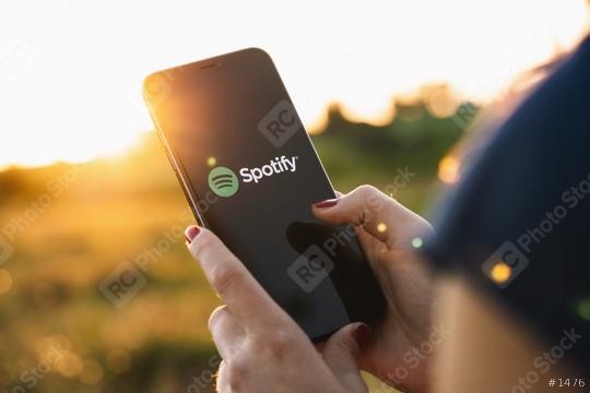 BERLIN, GERMANY JULY 2019: Woman holding a iPhone Xs opening spotify app, Spotify is a music service that offers legal streaming music.  : Stock Photo or Stock Video Download rcfotostock photos, images and assets rcfotostock | RC Photo Stock.: