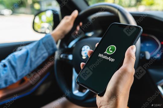 BERLIN, GERMANY JULY 2019: Woman holding a iPhone Xs opening Whatsapp app in a car. WhatsApp messenger for sending messages via the Internet.  : Stock Photo or Stock Video Download rcfotostock photos, images and assets rcfotostock | RC Photo Stock.: