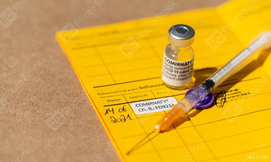 BERLIN, GERMANY JUNE 2021: Certificate of the first vaccination with Pfizer–BioNTech COVID-19 vaccine comirnaty, syringe and sticker in an international who vaccination certificate.    : Stock Photo or Stock Video Download rcfotostock photos, images and assets rcfotostock | RC Photo Stock.: