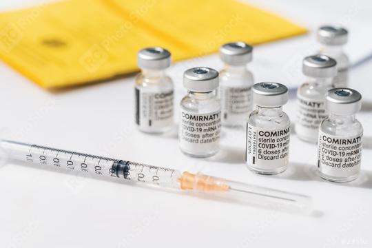 BERLIN, GERMANY JUNE 2021: Certificate of the first vaccination with Pfizer–BioNTech COVID-19 vaccine comirnaty, syringe and a international who vaccination certificate.    : Stock Photo or Stock Video Download rcfotostock photos, images and assets rcfotostock | RC Photo Stock.: