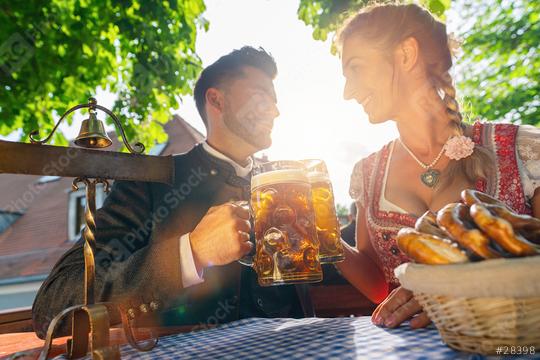 Best friends in Bavarian Tracht sitting in Beer garden or oktoberfest and enjoying a glass of beer and the sun  : Stock Photo or Stock Video Download rcfotostock photos, images and assets rcfotostock | RC Photo Stock.: