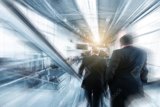 Blurred business people using a escalator on a  trade fair / messe  : Stock Photo or Stock Video Download rcfotostock photos, images and assets rcfotostock | RC Photo Stock.: