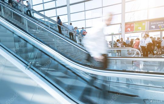 Blurred people using a escalator on a trade dair  : Stock Photo or Stock Video Download rcfotostock photos, images and assets rcfotostock | RC Photo Stock.: