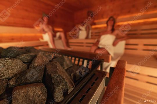 Blurry view of a sauna heater with stones in focus, and people in the background. Wellness Spa Hotel Conept image.  : Stock Photo or Stock Video Download rcfotostock photos, images and assets rcfotostock | RC Photo Stock.: