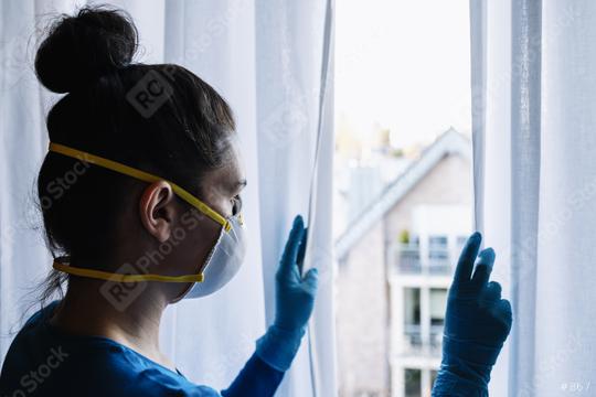 Bored woman in corona quarantine with protection mask fftp2 looking out of a window to the village   : Stock Photo or Stock Video Download rcfotostock photos, images and assets rcfotostock | RC Photo Stock.: