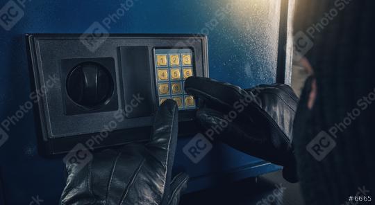 Burglar enter a code to crack a safe  : Stock Photo or Stock Video Download rcfotostock photos, images and assets rcfotostock | RC Photo Stock.:
