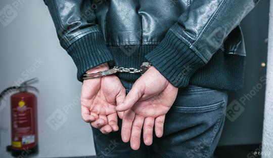 Burglar hands locked in handcuffs  : Stock Photo or Stock Video Download rcfotostock photos, images and assets rcfotostock | RC Photo Stock.: