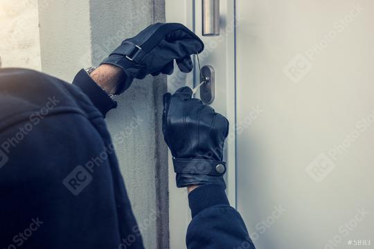 burglar holding Lock-picker to open a housedoor  : Stock Photo or Stock Video Download rcfotostock photos, images and assets rcfotostock | RC Photo Stock.: