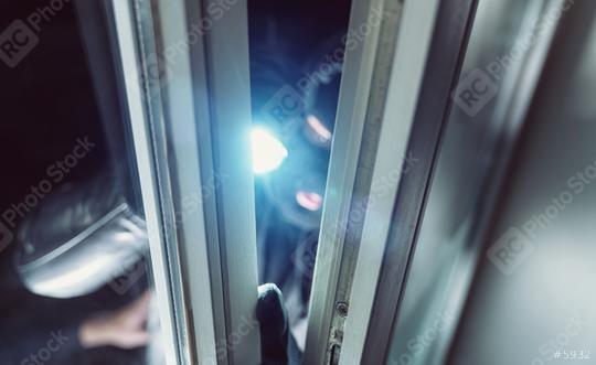 Burglar shines with flashlight in to a window of a house at night  : Stock Photo or Stock Video Download rcfotostock photos, images and assets rcfotostock | RC Photo Stock.: