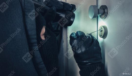 Burglar with lock picking tools and flashlight breaking into a house door  : Stock Photo or Stock Video Download rcfotostock photos, images and assets rcfotostock | RC Photo Stock.: