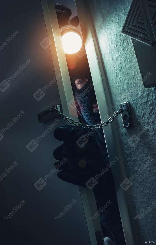 burglar with torch entering a door with chain at night  : Stock Photo or Stock Video Download rcfotostock photos, images and assets rcfotostock | RC Photo Stock.: