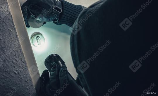burglar with torch entering into a house door   : Stock Photo or Stock Video Download rcfotostock photos, images and assets rcfotostock | RC Photo Stock.: