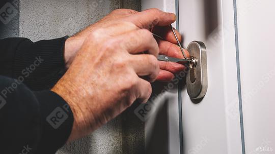 Burglars crack the front door with lock picking  : Stock Photo or Stock Video Download rcfotostock photos, images and assets rcfotostock | RC Photo Stock.: