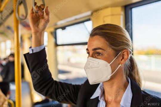 business woman wear surgical FFP2 mask face to protect herself while commuting in the metro or train  : Stock Photo or Stock Video Download rcfotostock photos, images and assets rcfotostock | RC Photo Stock.: