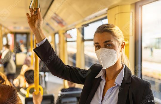 Business woman wearing surgical FFP2 protective holding on to a handle in a public transportation  : Stock Photo or Stock Video Download rcfotostock photos, images and assets rcfotostock | RC Photo Stock.: