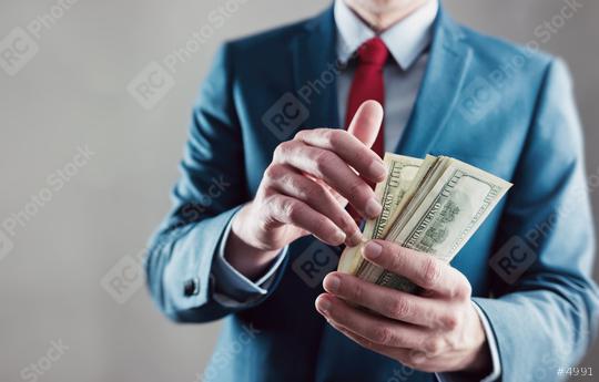 Businessman counting dollar notes  : Stock Photo or Stock Video Download rcfotostock photos, images and assets rcfotostock | RC Photo Stock.: