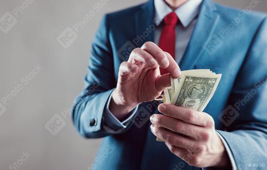 Businessman counting spread of money   : Stock Photo or Stock Video Download rcfotostock photos, images and assets rcfotostock | RC Photo Stock.: