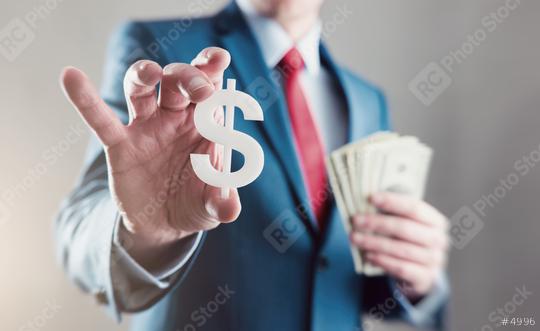 Businessman holding a dollar sign with a  Spread of Cash  : Stock Photo or Stock Video Download rcfotostock photos, images and assets rcfotostock | RC Photo Stock.: