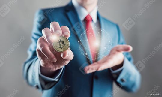 Businessman present a bitcoin - Bitcoin growth concept (new virtual money)   : Stock Photo or Stock Video Download rcfotostock photos, images and assets rcfotostock | RC Photo Stock.: