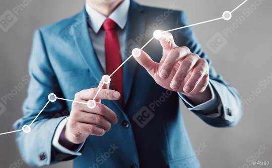 Businessman touching a growing graph  : Stock Photo or Stock Video Download rcfotostock photos, images and assets rcfotostock | RC Photo Stock.: