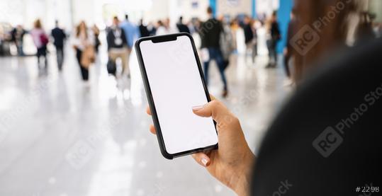 Businesswoman hand holding black cellphone with white screen at a trade fair, copyspace for your individual text.  : Stock Photo or Stock Video Download rcfotostock photos, images and assets rcfotostock | RC Photo Stock.: