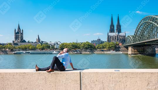 bussinesman spending his time at summer in Cologne  : Stock Photo or Stock Video Download rcfotostock photos, images and assets rcfotostock | RC Photo Stock.: