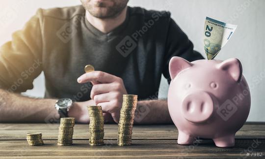 Calculating Financial money with Piggybank and Coins  : Stock Photo or Stock Video Download rcfotostock photos, images and assets rcfotostock | RC Photo Stock.: