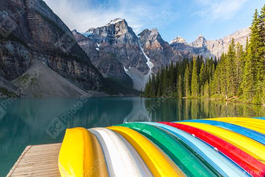 Canoes rest on the dock at Lake Moraine in the morning in canada  : Stock Photo or Stock Video Download rcfotostock photos, images and assets rcfotostock | RC Photo Stock.: