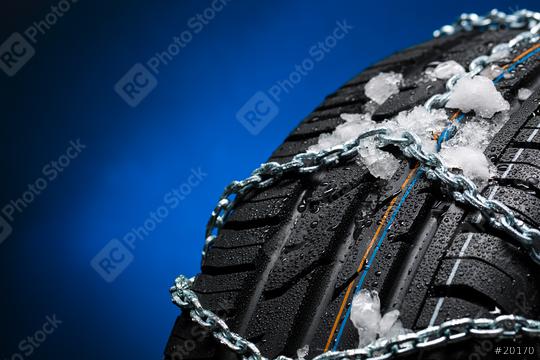 Car tire with ice and snow chains on blue background  : Stock Photo or Stock Video Download rcfotostock photos, images and assets rcfotostock | RC Photo Stock.: