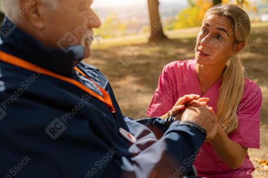 Caregiver holding hands with elderly man in wheelchair, conversation in autumn park, man wears SOS button. Dementia retirement home concept image  : Stock Photo or Stock Video Download rcfotostock photos, images and assets rcfotostock | RC Photo Stock.: