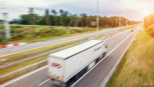 Cargo truck with cargo trailer driving on a highway. White Truck delivers goods in early hours of the Morning - very low angle drive thru close up shot.  : Stock Photo or Stock Video Download rcfotostock photos, images and assets rcfotostock | RC Photo Stock.: