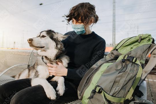 Casual Woman with backpack is waiting for the train with her dog on the platform and is wearing a face mask because of the coronavirus. Lovely  und happy friendship with your pet.  : Stock Photo or Stock Video Download rcfotostock photos, images and assets rcfotostock | RC-Photo-Stock.: