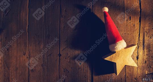 Christmas star with santa hat on wooden background, elegant low-key shot, including copy space  : Stock Photo or Stock Video Download rcfotostock photos, images and assets rcfotostock | RC Photo Stock.: