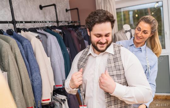 Client trying on a checkered jacket with tailor assisting in a boutique  : Stock Photo or Stock Video Download rcfotostock photos, images and assets rcfotostock | RC Photo Stock.: