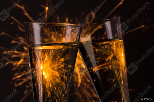 clink glasses with fireworks background on new year