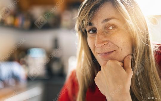 Close up  Woman Standing in the kitchen with Hand on the Chin. Captured her While Looking at the Camera indoors with copy space  : Stock Photo or Stock Video Download rcfotostock photos, images and assets rcfotostock | RC Photo Stock.: