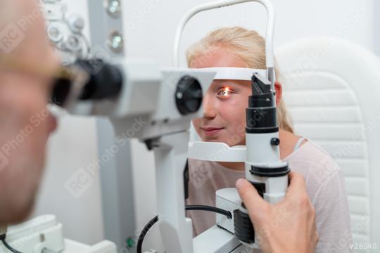 Close up shot of a girl checking vision with tonometer at eye clinic  : Stock Photo or Stock Video Download rcfotostock photos, images and assets rcfotostock | RC Photo Stock.: