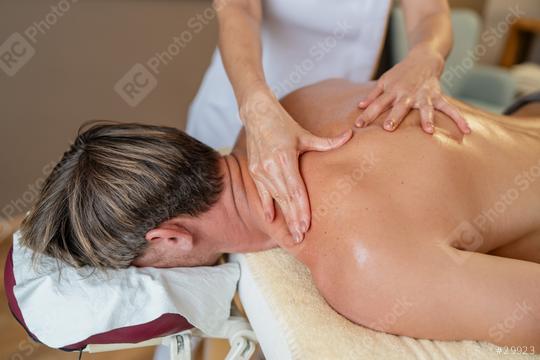 Close-up of a massage therapist working on a client