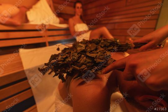 Close-up of a vihta (birch whisks) being used on a back of a man in a finish sauna, with others in the background  : Stock Photo or Stock Video Download rcfotostock photos, images and assets rcfotostock | RC Photo Stock.: