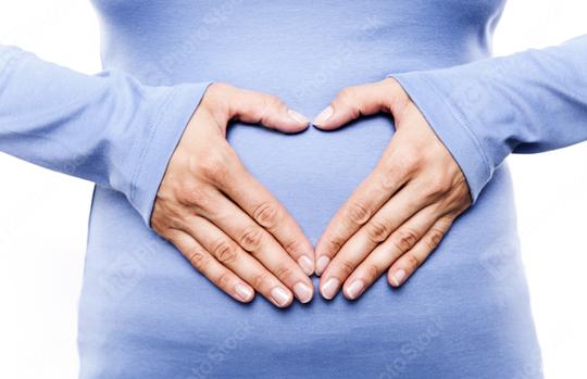 Close-up of a woman in a blue shirt forming a heart shape with her hands on her belly, symbolizing love, care, pregnancy, and motherhood  : Stock Photo or Stock Video Download rcfotostock photos, images and assets rcfotostock | RC Photo Stock.: