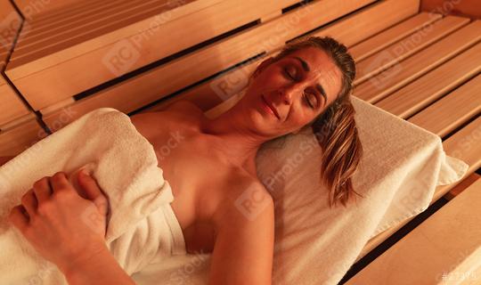 Close-up of a woman relaxing in a Finnish sauna at a hotel, warm tones, wooden backdrop. Spa and Wellness concept image  : Stock Photo or Stock Video Download rcfotostock photos, images and assets rcfotostock | RC Photo Stock.: