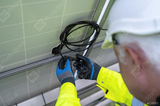 Close-up of an engineer connecting cables on solar panels. Alternative energy ecological concept image.  : Stock Photo or Stock Video Download rcfotostock photos, images and assets rcfotostock | RC Photo Stock.: