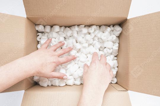 Closeup of female hands digging in a heap of packing peanuts in cardboard  : Stock Photo or Stock Video Download rcfotostock photos, images and assets rcfotostock | RC Photo Stock.: