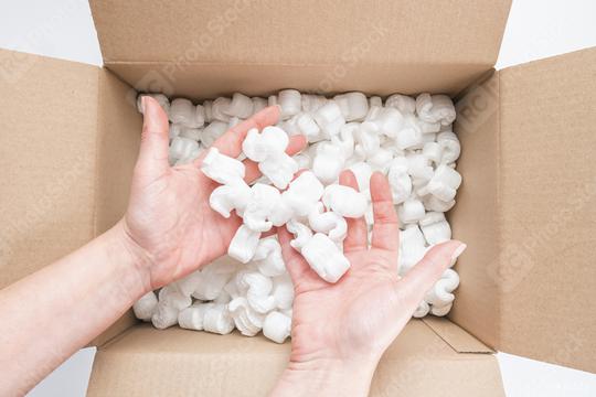 Closeup of female hands holding heap of packing peanuts in cardboard  : Stock Photo or Stock Video Download rcfotostock photos, images and assets rcfotostock | RC-Photo-Stock.: